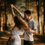 Romance - man and woman dancing at center of trees