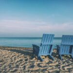 Retirement - two blue beach chairs near body of water