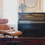Music Therapy - black upright piano near brown leather padded chair