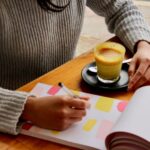 Meal Planning - person holding pen with coffee on table