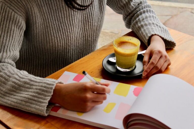 Meal Planning - person holding pen with coffee on table