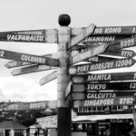 Destinations - grayscale photo of street sign