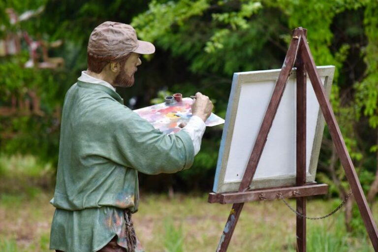 Weekend Getaway - a statue of a man holding a paintbrush and painting a picture