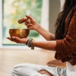 Meditation - woman in brown knit sweater holding brown ceramic cup