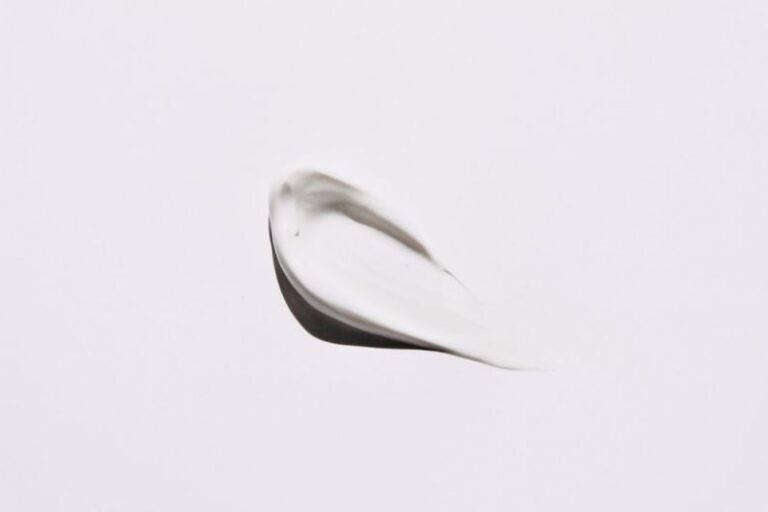 Skincare - stainless steel spoon on white surface