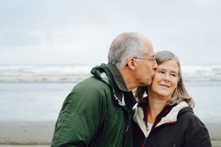 Anti-Aging - man kissing woman on check beside body of water