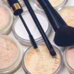 Makeup - three makeup brushes on top of compact powders